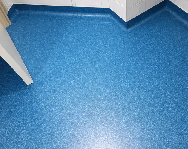 Blue safety vinyl flooring with neatly fitted coved edges
