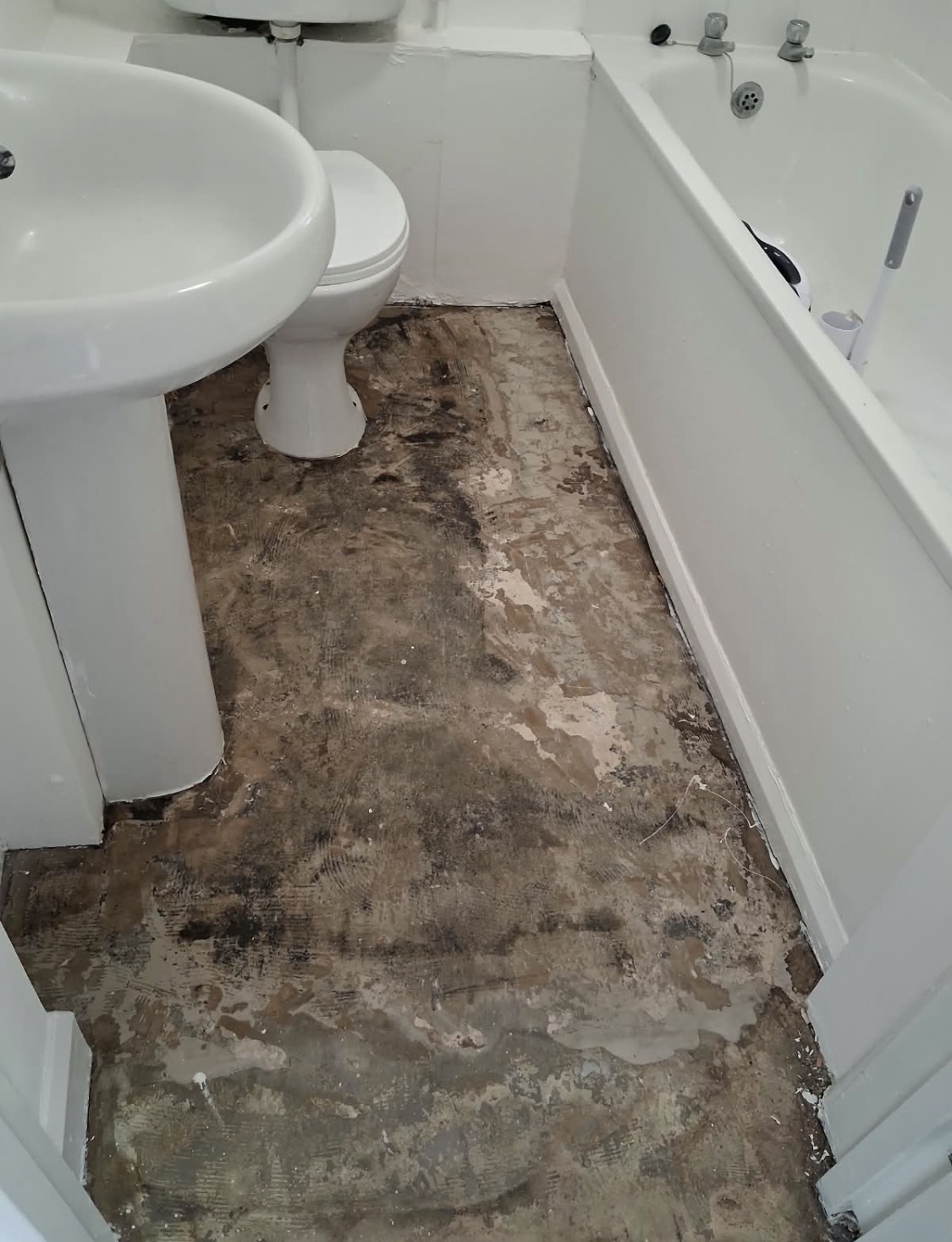 Bathroom subfloor exposed after removal of the existing flooring